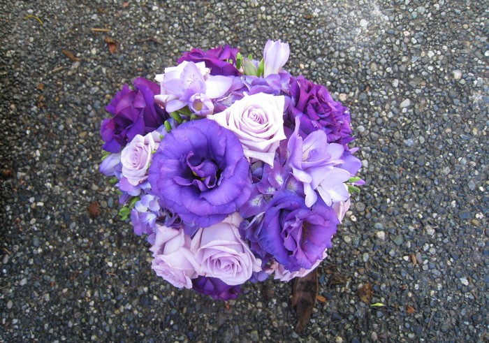 Purple and lavender flower bouquet on gravel