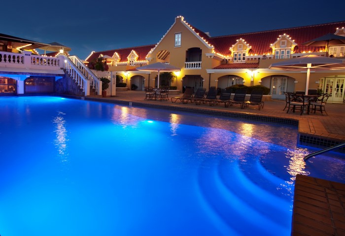 Hotel with pool and lights at night