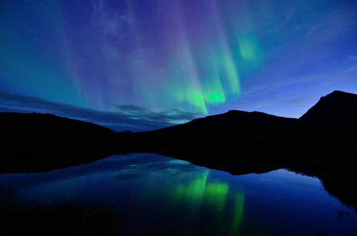 Aurora Borealis over a lake in Norway at night