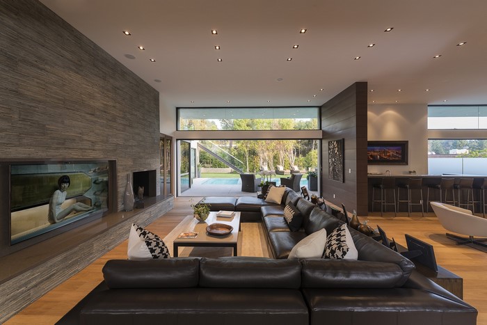 Modern living room with fireplace and view of pool