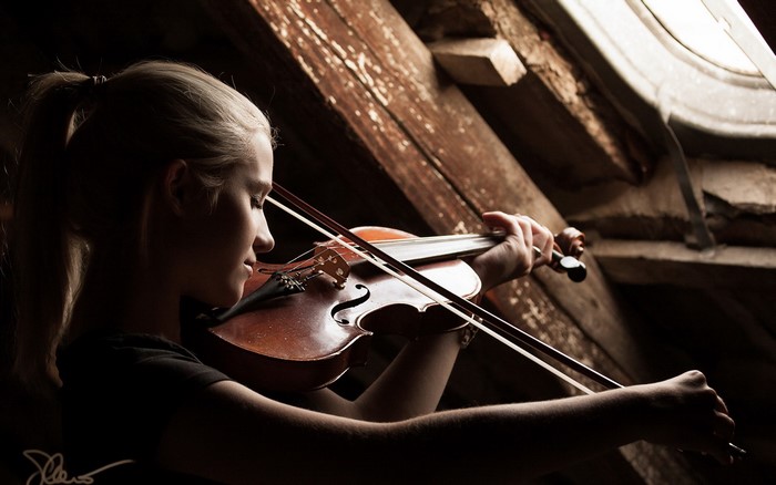 Girl playing violin in attic