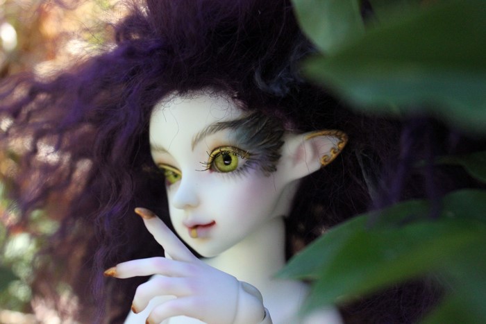 Elf doll with purple hair and green eyes