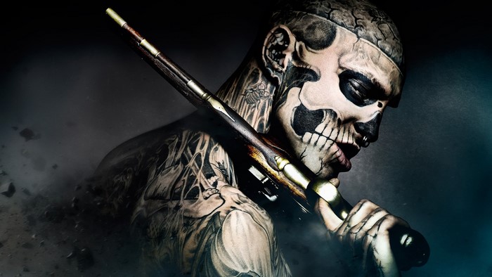 Man with skull tattoos holding a rifle