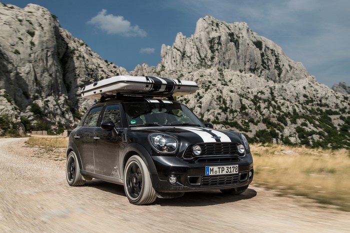 Black Mini Countryman Cooper S ALL4 with roof tent in mountains