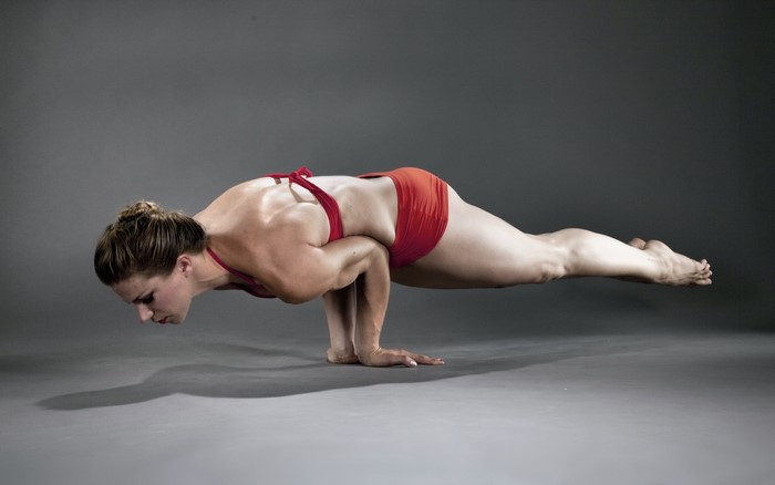 Woman performing a yoga pose on hands
