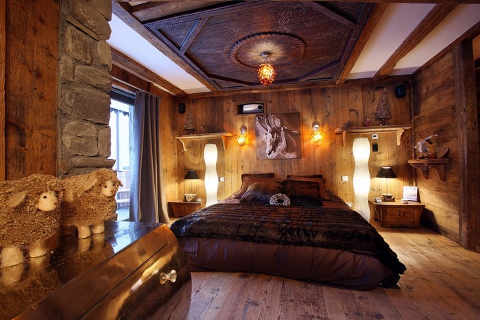 Cozy wooden bedroom with a large bed and decorative sheep