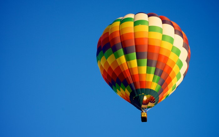 Colorful hot air balloon in a clear blue sky