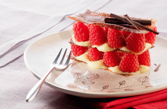 Raspberry Mille-feuille dessert with cream and chocolate on a plate