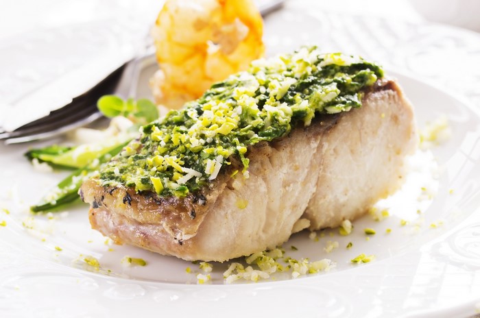 Fish fillet with green topping and shrimp