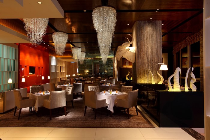 Restaurant interior with chandeliers, tables, and chairs