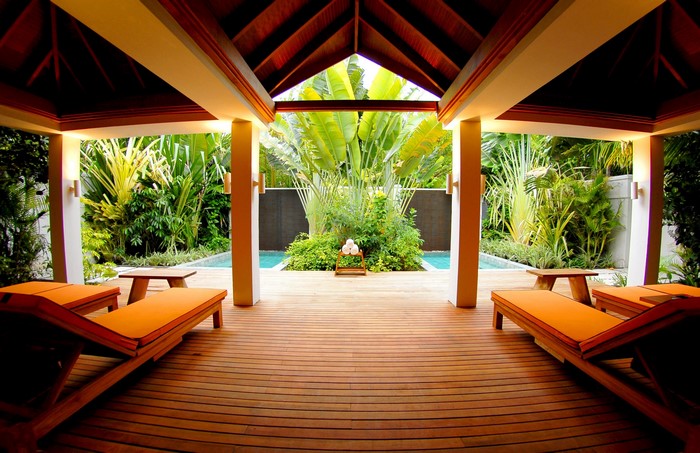 Resort lounge chairs by a tropical pool in the Maldives