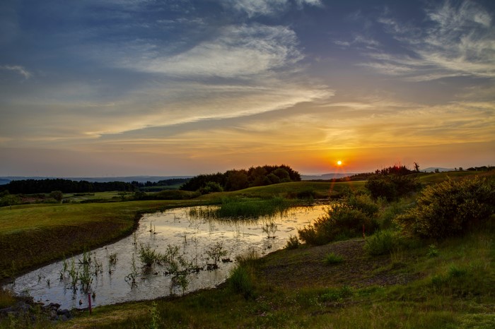 Sunset over a pond and golf course