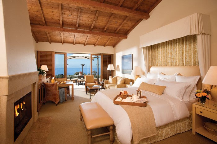 Luxury bedroom with fireplace and ocean view