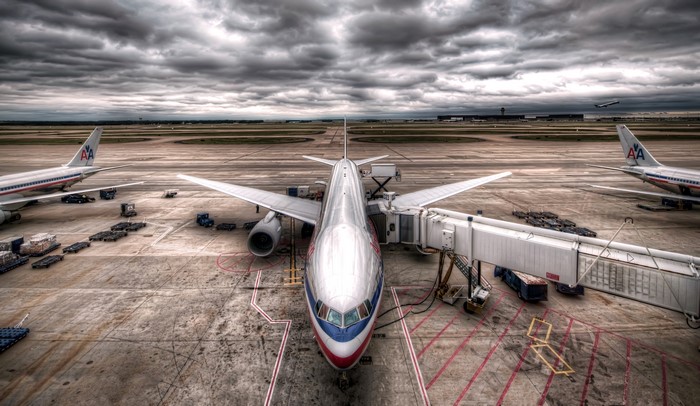 Boeing 777 airplane at airport gate with jet bridge