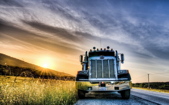 Peterbilt truck at sunset on a rural road