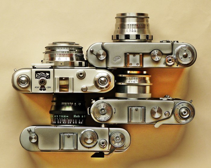 Four vintage cameras stacked together