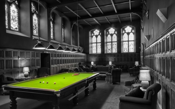 Billiard room with stained glass windows and armchairs