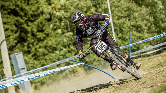 Downhill mountain biker wearing helmet and gear