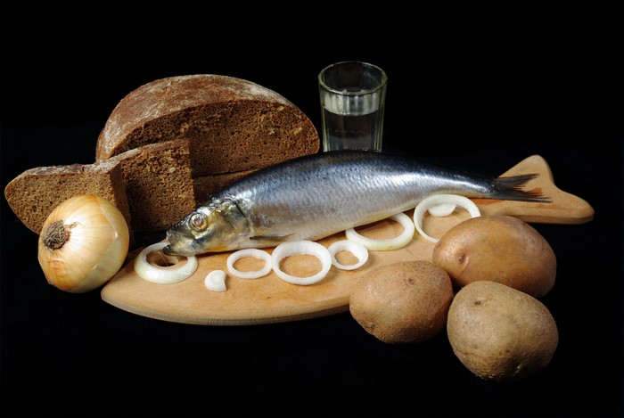 Still-life with herring, bread, potatoes, onion, and vodka