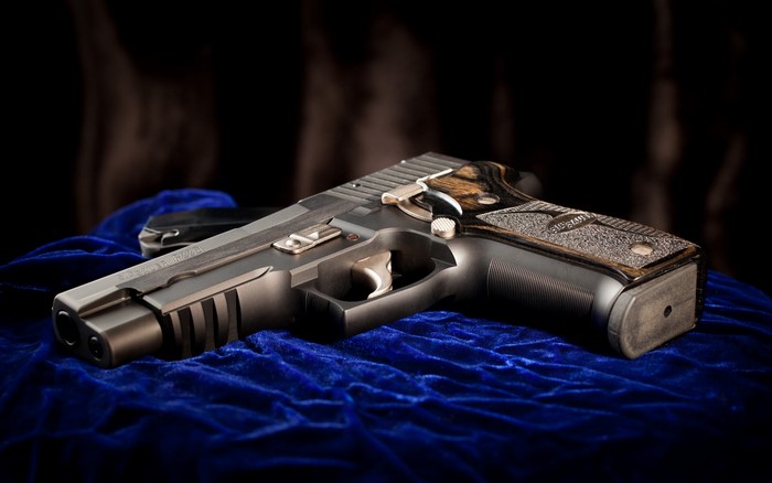 Sig Sauer P226 pistol on blue velvet