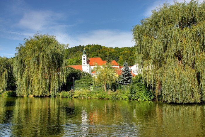 River with Monastery and Weeping Willows in Bavaria, Germany