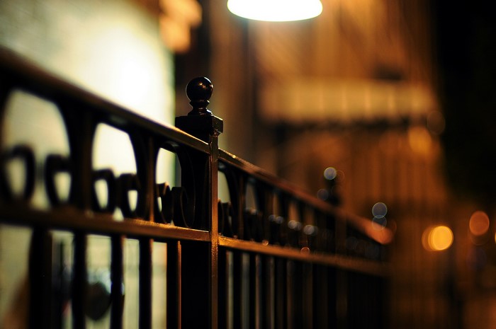 Close-up of a black metal fence at night