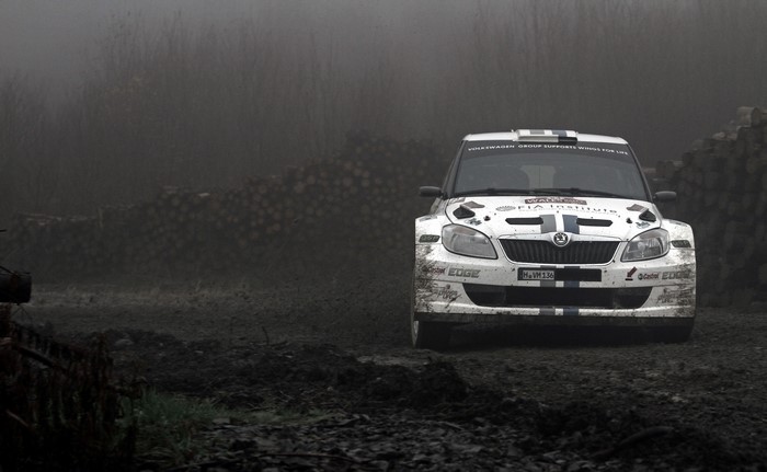 White Skoda Fabia rally car on a dirt track