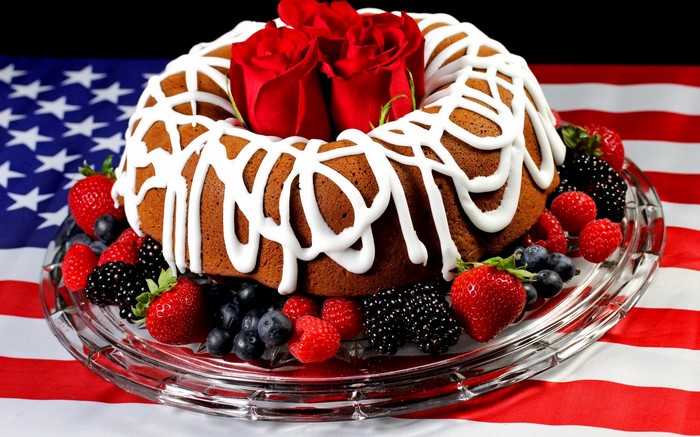 Bundt cake with berries and roses on American flag