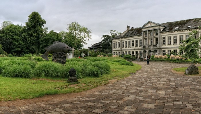 Pairi Daiza castle with fish sculpture and gardens