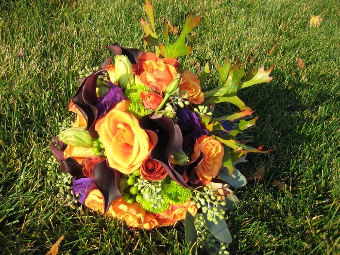 Autumn bouquet of roses and calla lilies on grass