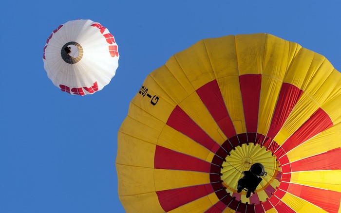 Two hot air balloons flying in the sky