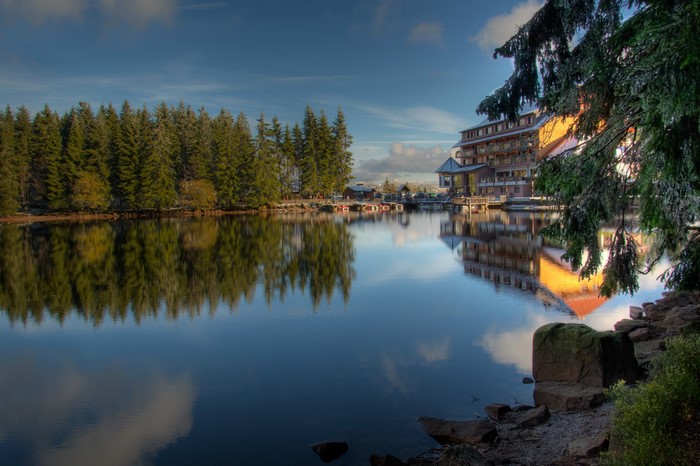 Hotel on a lake with forest reflection in Seebach, Germany