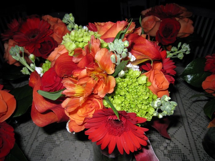 Orange and red flower bouquets with green accents
