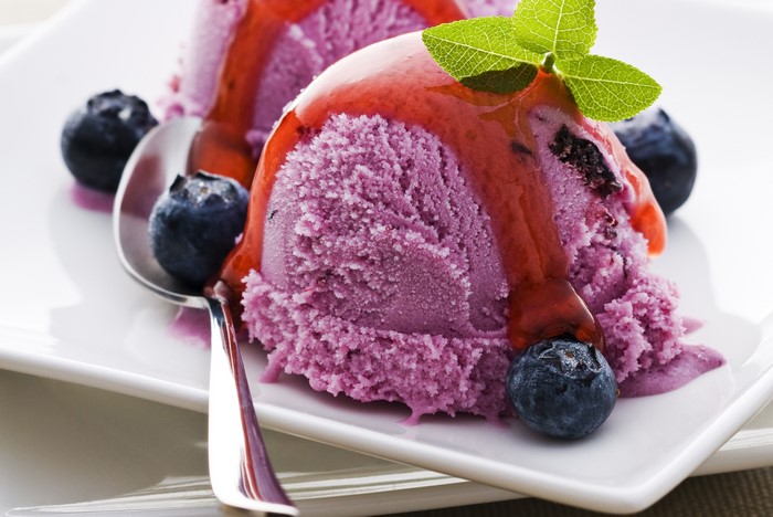Blueberry ice cream with sauce and blueberries