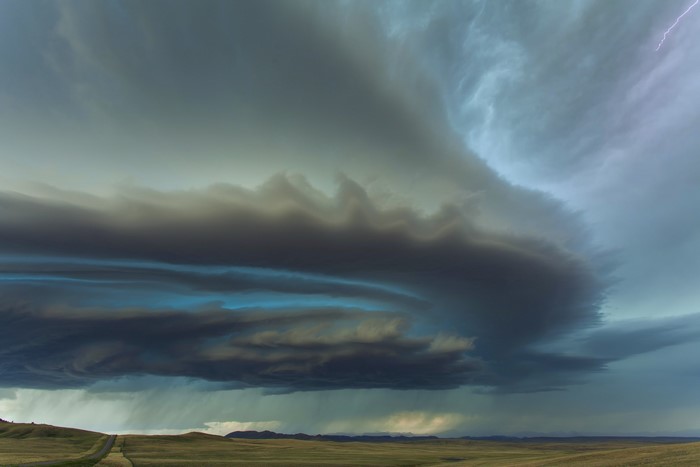 Stormy Sky with Lightning over a Grassy Field