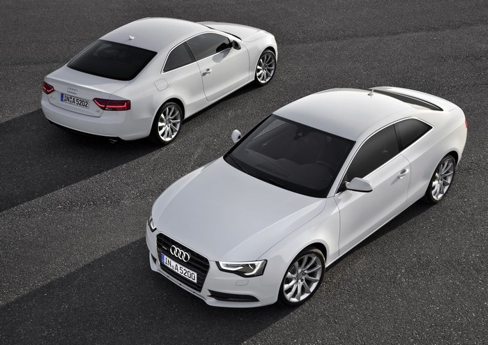 Two white Audi A5 Coupe cars on asphalt