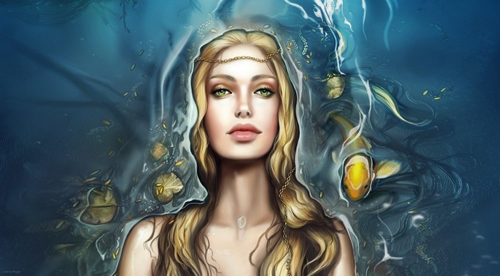 Woman with blonde hair and green eyes in water with fish