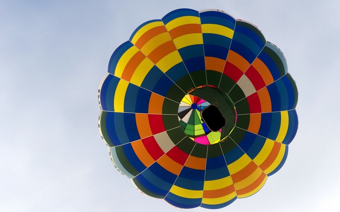 View from below of a colorful hot air balloon