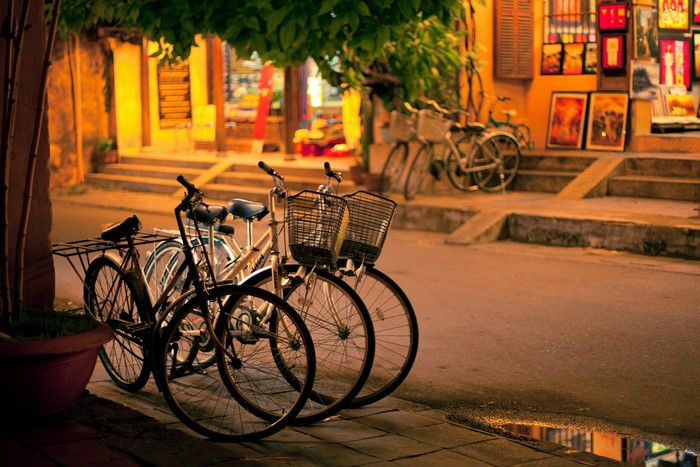 Bicycles parked on a street at night