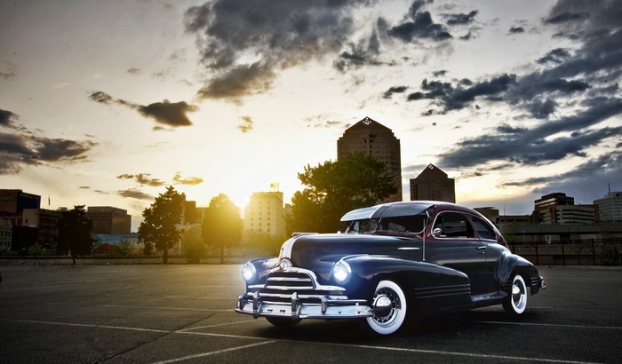 Blue 1940s Pontiac Streamliner 8 car at sunset