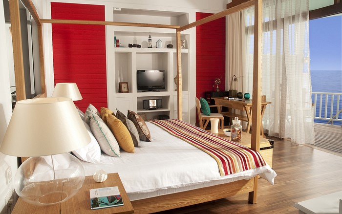 Bedroom with four-poster bed and ocean view