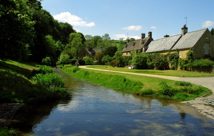 Cotswolds village with stream and stone cottages
