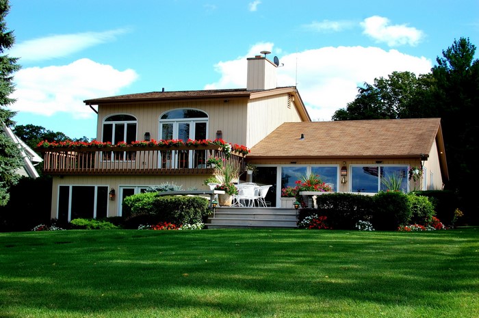 House with a deck and lawn