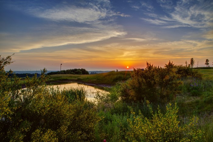 Sunset over a pond and golf course in Germany