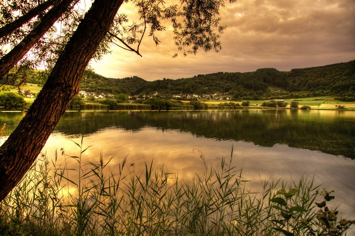Lake Meerfeld with trees and hills in Germany