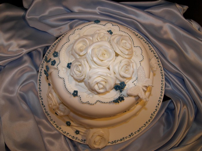 White rose cake with blue floral accents
