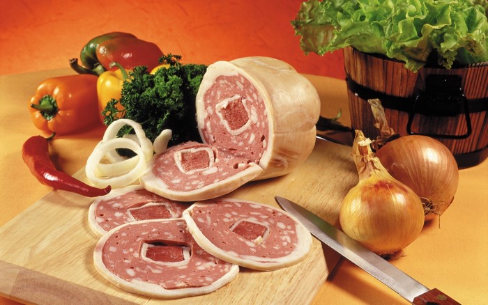 Sausage, vegetables, and onions on a cutting board