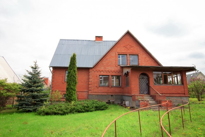 Brick house with trees and lawn