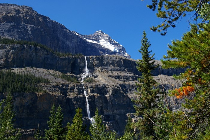 Waterfall cascading down a rocky mountain in Robson Provincial Park, Canada