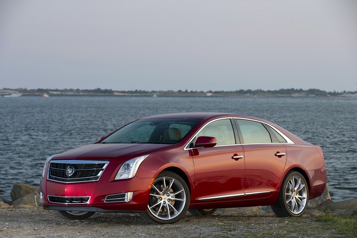 Red Cadillac XTS Vsport Sedan by the Water